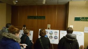 Attendees give their input by placing stickers on the areas they would most like see developed from the riverfront project. (City Times Photo)