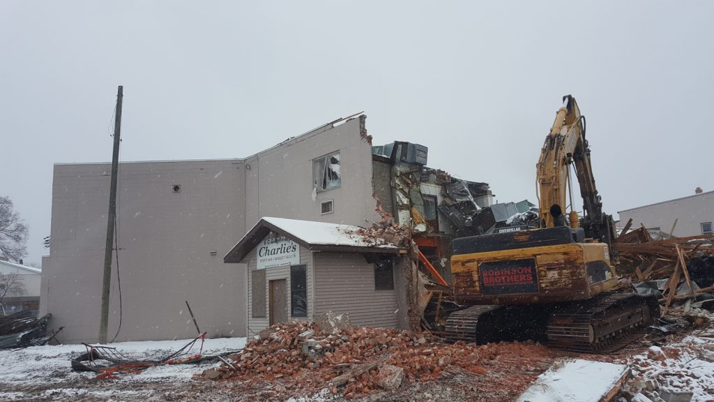 An excavator tears into the Good Time Charlie's building as part of the demolition process. (City Times Photo)